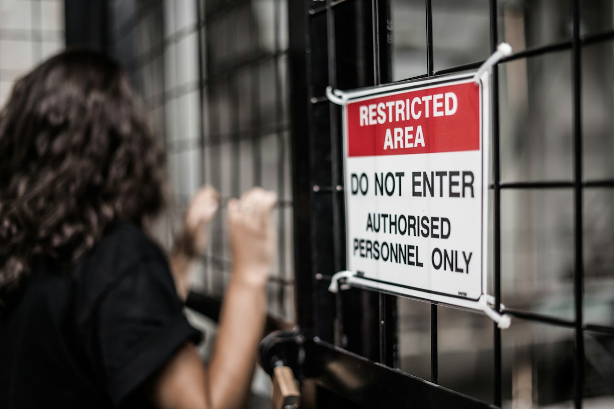 Restricted Area sign on a chain-link fence